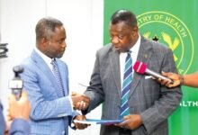 Prof. Akosa (right) presenting the report to Mr Akandoh during the meeting