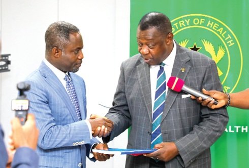 Prof. Akosa (right) presenting the report to Mr Akandoh during the meeting