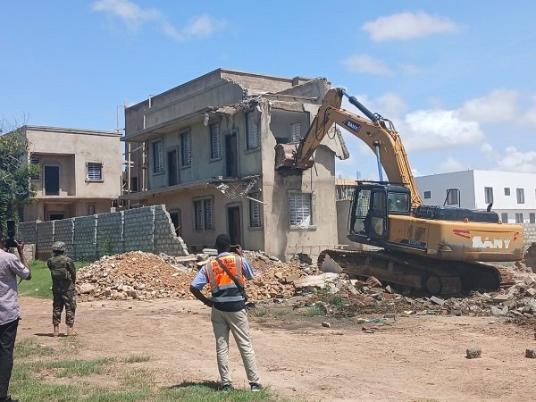 An execavator demolishing one of the illegal structures at the Ramsar site