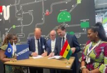 Mr Said (right) and Mr Vyncke signing the partnership agreement