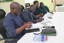 Alhaji Haruna (left), Alhaji Faila (second from left) and Mr Johnson signing the MoU