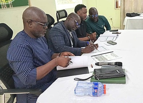 Alhaji Haruna (left), Alhaji Faila (second from left) and Mr Johnson signing the MoU