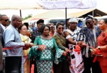 • Vice President Opoku-Agyemang (third from left) cutting the tape to inaugurate the new MMT buses. With her is Mr Joseph Bukari Nikpe, Transport Minister (left) and other dignitaries