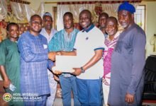 Alhaji Mahama (second from right) handing over the money to Mr Dawuda