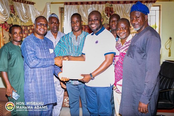 Alhaji Mahama (second from right) handing over the money to Mr Dawuda