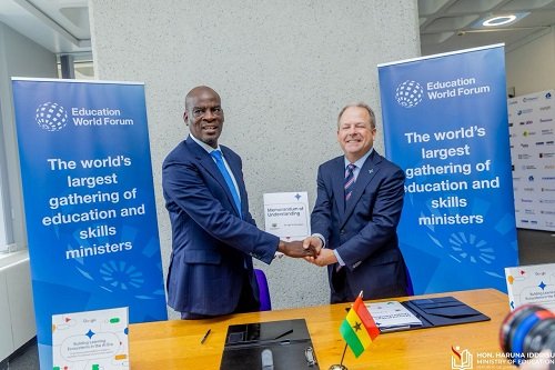 Mr Iddrisu (left) exchanging the signed document with Mr Kells at the ceremony