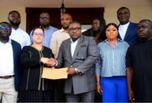 Mr Henry Nana Boakye (in suit) presenting the petition to Moroccan Ambassador to Ghana, Imane Ouaadil