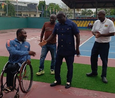 • Mr K. Appiah interacts with a para athlete while Mr Amofa (right) and Mr Chartey Annan, an official look on