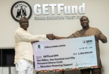 Mr Marteye (right) presenting a dummy cheque to Mr Adjei