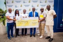 Mr Simeone-Okraku (third right) with Mr Elliot Twum (third lleft) and other officials display the dummy cheque