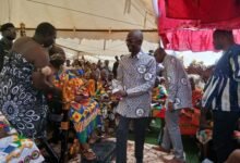 Mr Asiedu Nketiah exchanging greetings with the chiefs at the programme