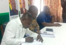 Mr Kokroko (left) and Mr Gunu signing the agreement