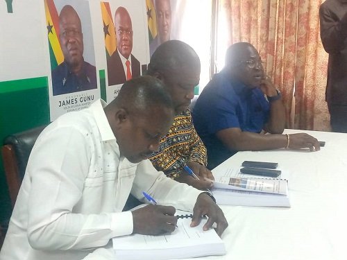 Mr Kokroko (left) and Mr Gunu signing the agreement