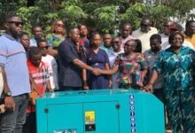 Mr Bonsu (with mic) handing over the power plant to Ms Sekyere.