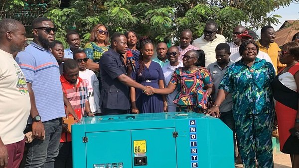 Mr Bonsu (with mic) handing over the power plant to Ms Sekyere.