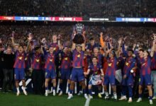 Players of Barcelona celebrate with the trophy after the game