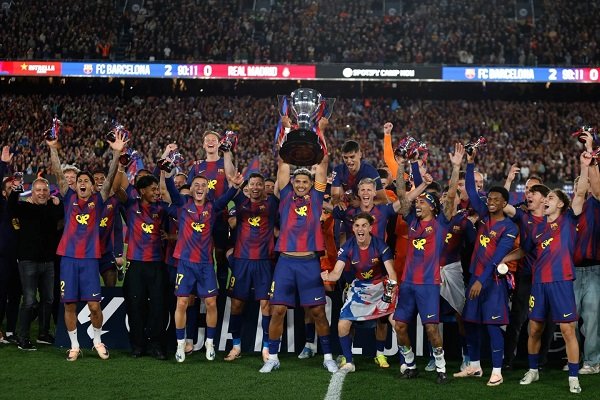 Players of Barcelona celebrate with the trophy after the game