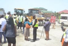 Mr Anyetei (second from right) being interviewed after inspecting the road... Photo Victor A. Buxton