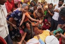 Relatives mourn besides the body of Summit Yadav, who died after a wall of his neighbour collapsed