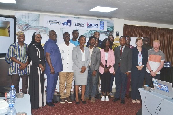 Mr Asante-Twum (fourth from left) with Ms Anti (sixth from right) and other participants during the stakeholders dialoque. ,