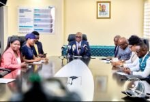 Dr Bampoe (head of table) addressing the press conference