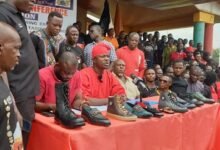 Mr Ntim(in red smoke) addressing the press