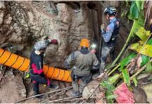 Some of the rescuers at the entrance of the flooded Laos cave