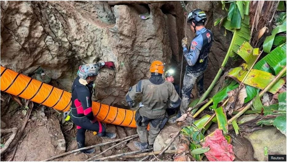 Some of the rescuers at the entrance of the flooded Laos cave