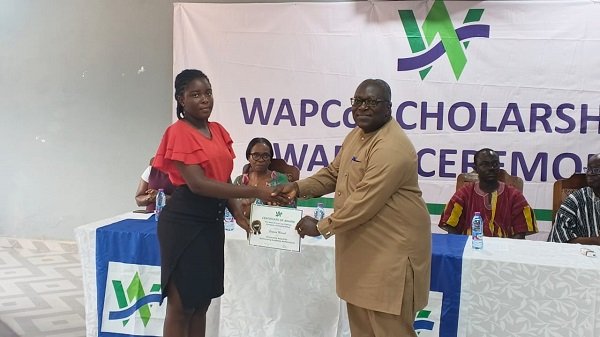 Dr Doku (right) presenting a certificate to Ms Mensah, a Fashion Design student at the TTU