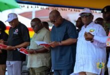 President Mahama (second from right), Mr Joshua Ansah (right) and other dignitaries singing workers solidarity song at the celebration