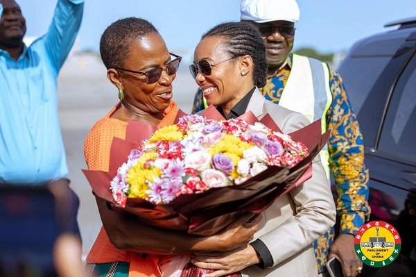 Dr Zanetor (right) receiving a bouquet of flower on her arrival from Mrs Cudjoe, MP of Ada