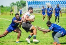 Skolars Illyassu Musbawu (white) meandering his way through a tackle two Tigers players