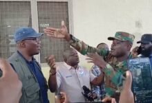 A Military officer and some Members of Parliament in a discussion during the visit