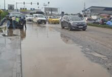 A Trotro driver stuck in one of the potholes on the street whiles others avoid large sections of the road Photo Victor A. Buxton