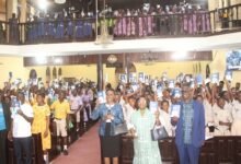 Officials from the Bible Society of Ghana and students raising their Bibles after the distribution at the launch. Photo Ebo Gorman
