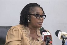 Ms Rita Akosua Awatey (inset) addressing the gathering during the meeting