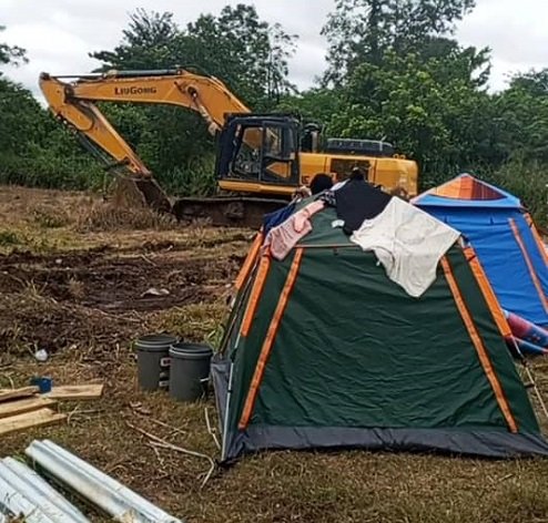 An excavator on the disputed land at Jinijini