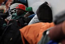 Displaced migrants shelter in a hall, following an escalation in anti-immigrant protests