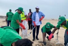 Amb. Gana, (wearing a cap), and volunteers cleaning the beach