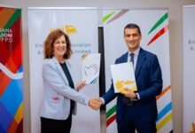 Ms Forcella (left) and Mr Pinna showing the signed document at the ceremony