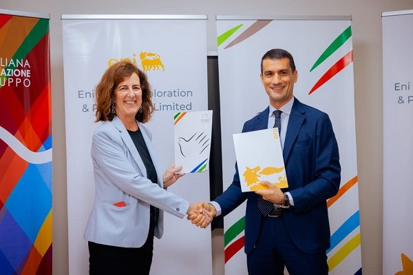Ms Forcella (left) and Mr Pinna showing the signed document at the ceremony