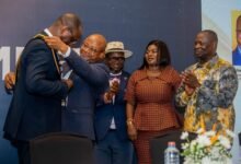 • Mr Akafia (second from left ) adorns Mr Attakumah with a sash as he hands over the GCM Presidency. Looking on are Mr Armah Kofi-Buah (right) and other dignitaries