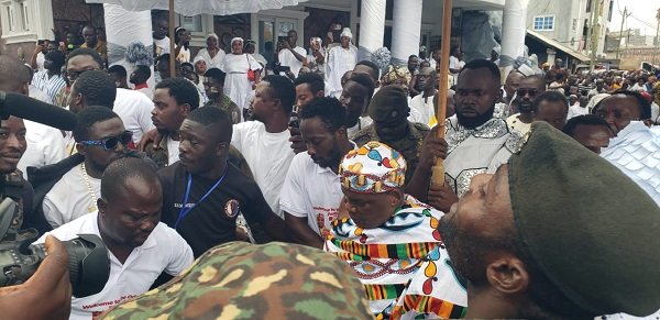 Nii Gbese (in kente cloth) being heralded to the Fontomfron drums