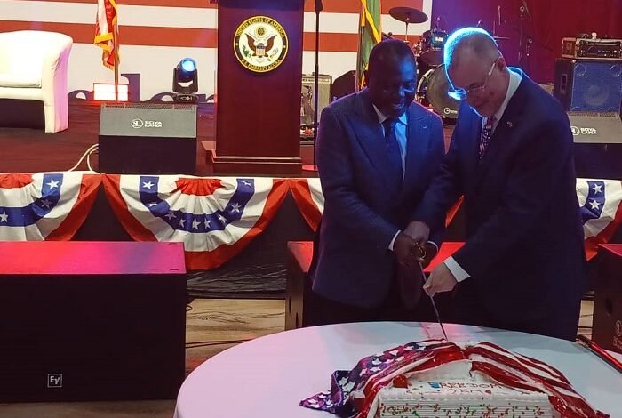 Mr Olson (right) and Dr Ayine cutting the anniversary cake