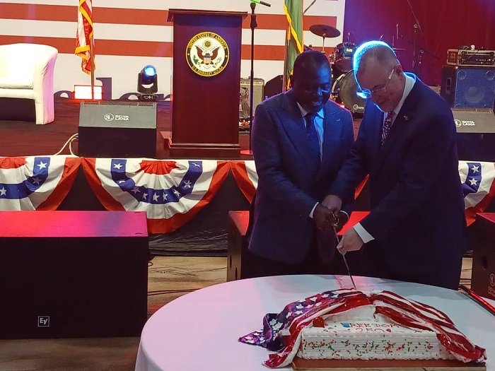 Mr Olson (right) and Dr Ayine cutting the anniversary cake