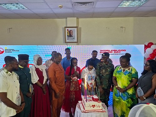 Dr Owusu-Ofori (fourth from right) cutting the cake to commence the day