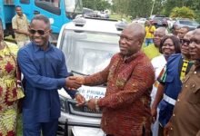 Mr. Akandoh, (second from left), handing over keys to the vehicles to Mr. Gunu during the launch ceremony