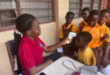 A student being screened while others wait for their turn
