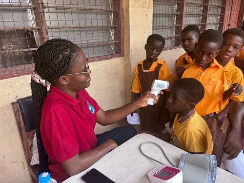 A student being screened while others wait for their turn