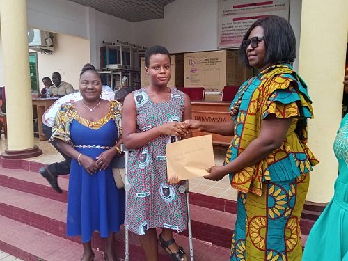 Mrs Mawutor (right) presenting money to one of the beneficiaries